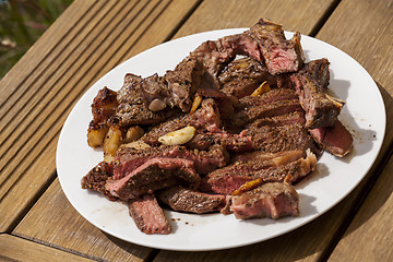 Image showing Plate of Grilled Steak and Garlic with Red Napkin