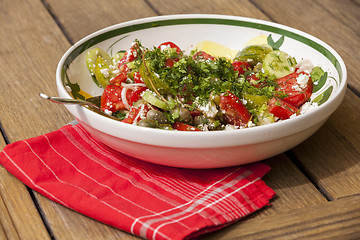 Image showing Bowl of Marinated Greek Salad with Red Napkin