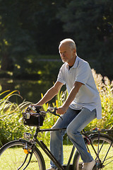 Image showing Senior Man Riding Bicycle