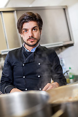 Image showing Chef cooking a vegetables stir fry over a hob