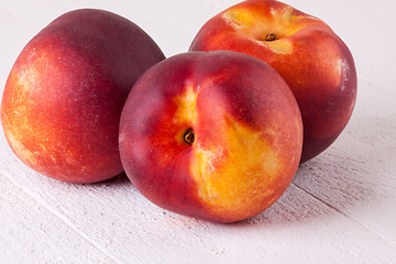 Image showing Three tasty fresh ripe juicy nectarines