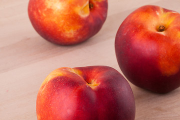 Image showing Three tasty fresh ripe juicy nectarines