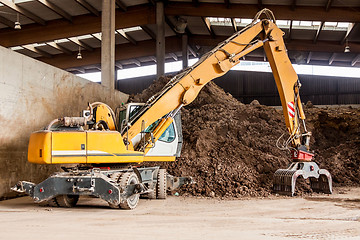 Image showing Heavy duty excavator doing earth moving