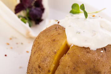 Image showing Baked jacket potato with sour cream sauce