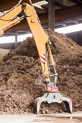 Image showing Heavy duty excavator doing earth moving