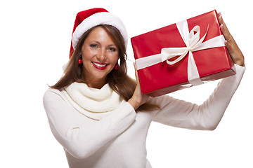 Image showing Pretty woman in a Santa hat with a large gift