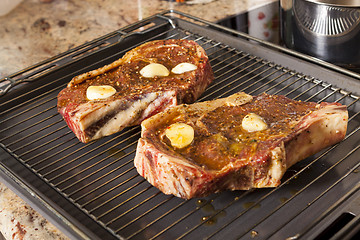 Image showing Two Steaks Marinated with Oil and Garlic on Grill