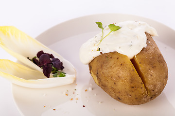 Image showing Baked jacket potato with sour cream sauce