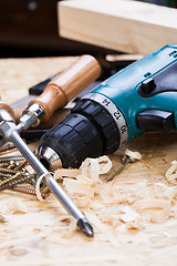 Image showing Drill with timber, screwdrivers and screws