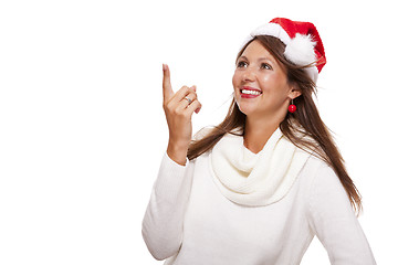 Image showing Young woman in a Santa hat holding out her hands