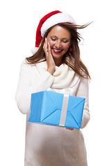 Image showing Beautiful vivacious woman with a Christmas gift