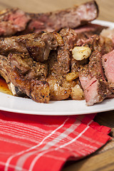 Image showing Plate of Grilled Steak and Garlic with Red Napkin