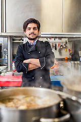 Image showing Chef cooking a vegetables stir fry over a hob