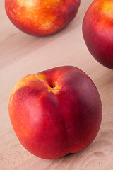 Image showing Three tasty fresh ripe juicy nectarines