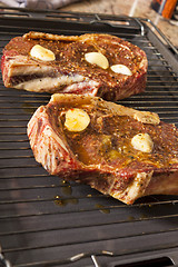 Image showing Two Steaks Marinated with Oil and Garlic on Grill
