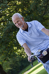 Image showing Senior Man Riding Bicycle