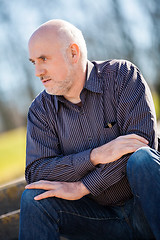 Image showing Thoughtful man sitting on a flight of steps