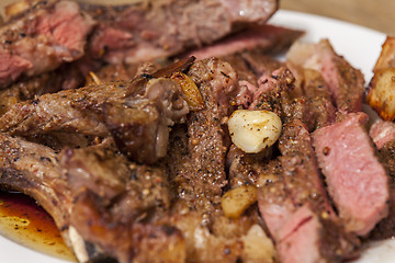 Image showing Plate of Grilled Steak and Garlic with Red Napkin