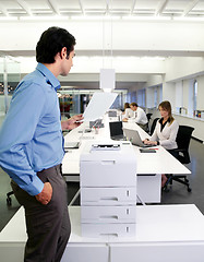 Image showing worker with copy machine in office