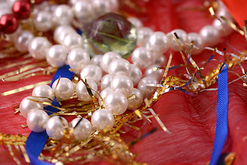 Image showing String of pearls on red background