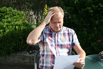 Image showing Swedish man is reading letter