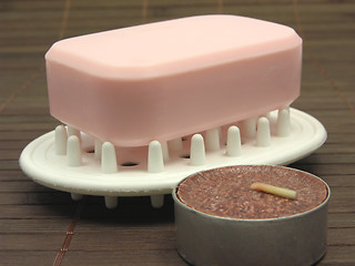 Image showing Pink soap with tea light on a  brown background