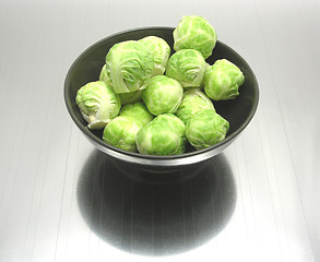 Image showing Bowl of chinaware with brussels sprouts on reflecting matting