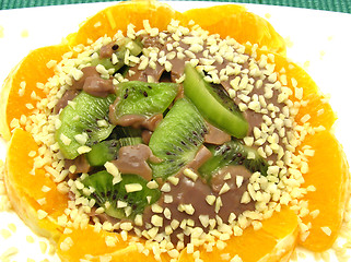 Image showing Chocolate pudding with kiwi fruit, orange and little pieces of a