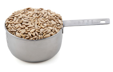 Image showing Hulled sunflower seeds in a cup measure
