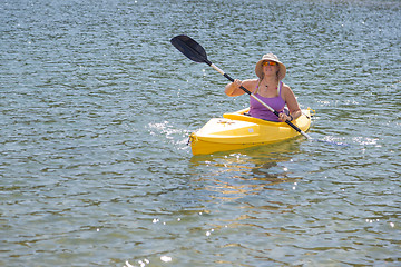 Image showing Woman Kayaking on Beautiful Mountain Lake.