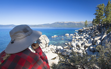 Image showing Woman Looking Over Beautiful Shoreline of Lake Tahoe.