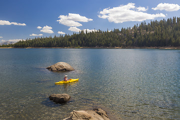 Image showing Woman Kayaking on Beautiful Mountain Lake.