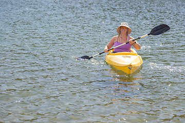 Image showing Woman Kayaking on Beautiful Mountain Lake.