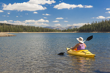 Image showing Woman Kayaking on Beautiful Mountain Lake.