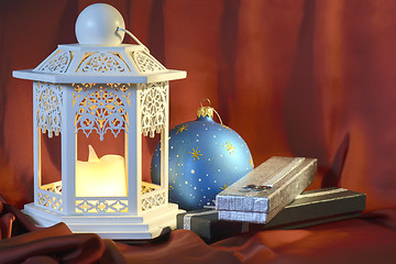 Image showing Old glowing lantern on red background