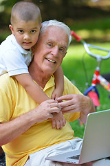 Image showing grandfather and child using laptop