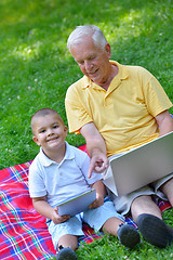 Image showing grandfather and child using laptop