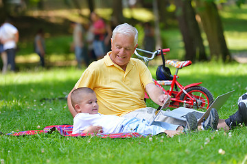 Image showing grandfather and child using laptop