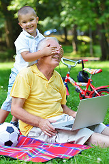 Image showing grandfather and child using laptop