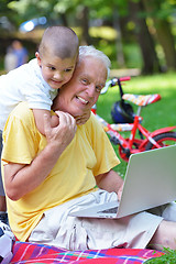 Image showing grandfather and child using laptop