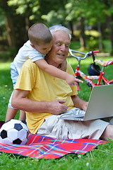 Image showing grandfather and child using laptop