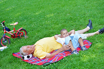 Image showing grandfather and child in park using tablet