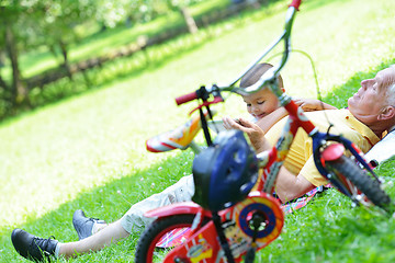 Image showing grandfather and child in park using tablet