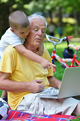 Image showing grandfather and child using laptop