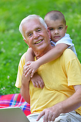 Image showing grandfather and child using laptop