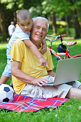 Image showing grandfather and child using laptop