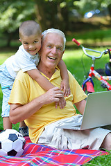 Image showing grandfather and child using laptop