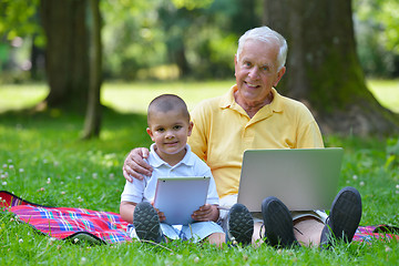 Image showing grandfather and child using laptop