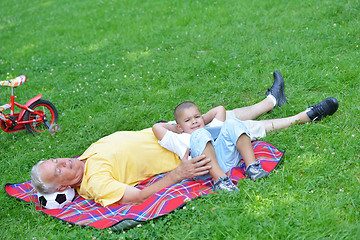 Image showing grandfather and child in park using tablet