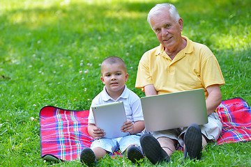 Image showing grandfather and child using laptop